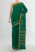 Pure Silk Green Kanjivaram Saree with Zari Butta on the body and Zari Border.  displayed on a mannequin