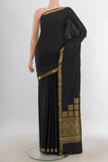 Pure Silk Black Kanjivaram Saree with Plain Body and Zari Border.  displayed on a mannequin