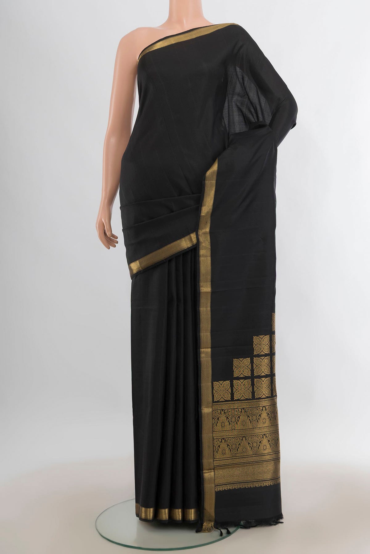 Pure Silk Black Kanjivaram Saree with Plain Body and Zari Border.  displayed on a mannequin