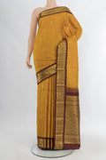 Mustard Kanchipuram Silk Saree with Zari Butta on the body and Zari Border.  displayed on a mannequin