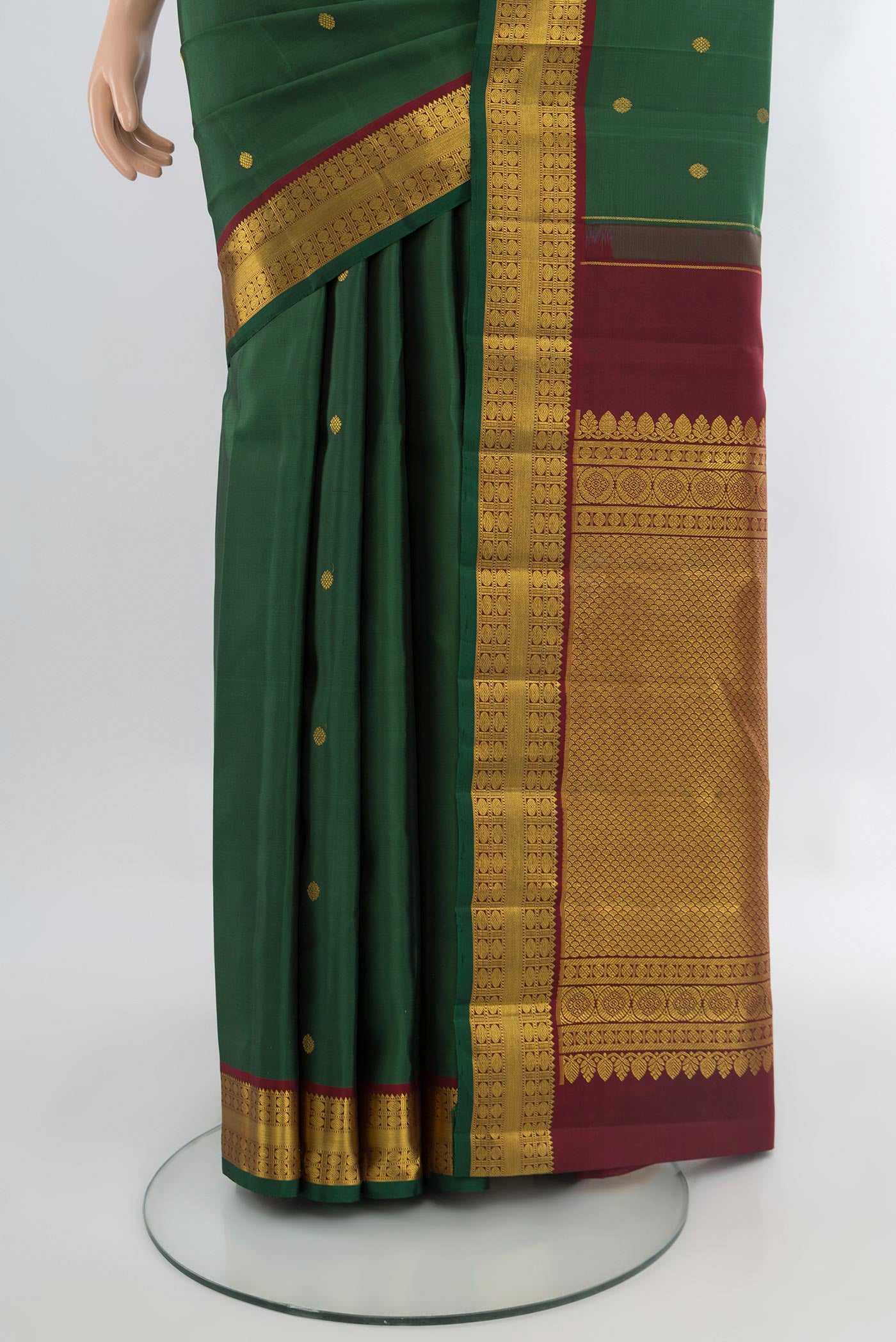 Pleats and pallu of Bottle Green Kanchipuram Silk Saree with Zari Butta on the body and Zari Border. 