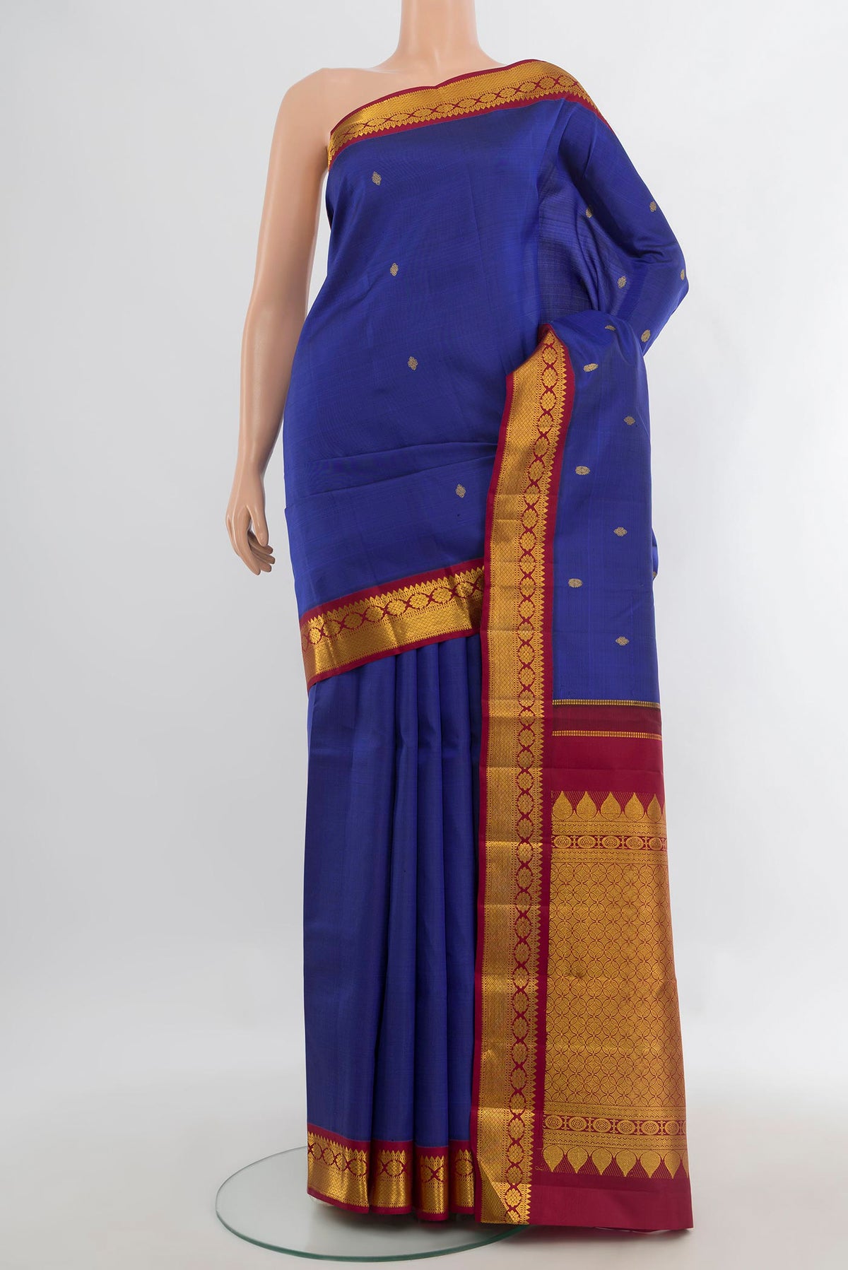 Pure Silk Dark Blue Kanchipuram Saree with Zari Butta on the body and Zari Border.  displayed on a mannequin