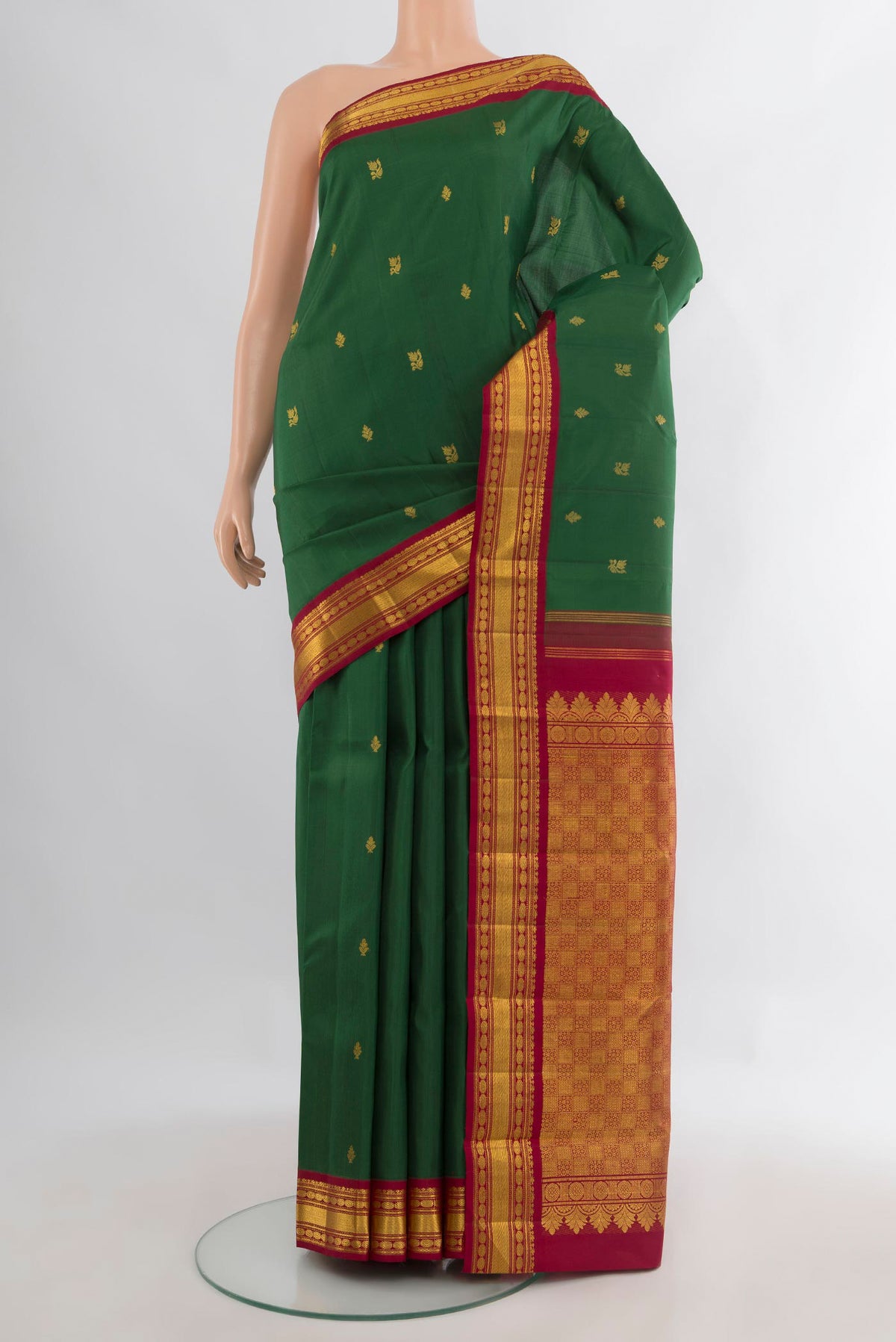 Pure Silk Pure Zari Bottle Green Kanchipuram Saree with Zari Butta on the body and Zari Border.  displayed on a mannequin