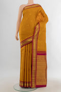 Pure Silk Pure Zari Mustard Kanchipuram Saree with Zari Butta on the body and Silk Border.  displayed on a mannequin
