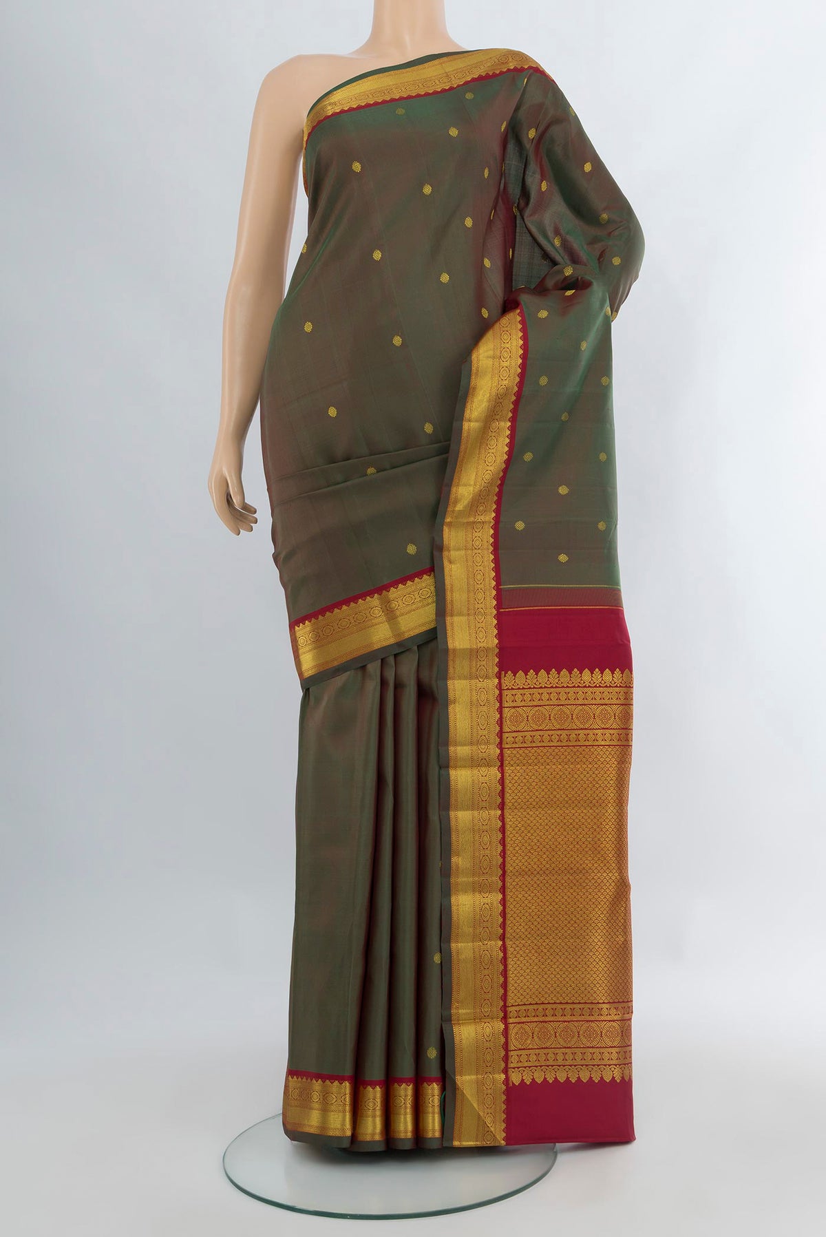 Mehandi Green Dual Tone Kanchipuram Silk Saree with Zari Butta on the body and Zari Border.  displayed on a mannequin