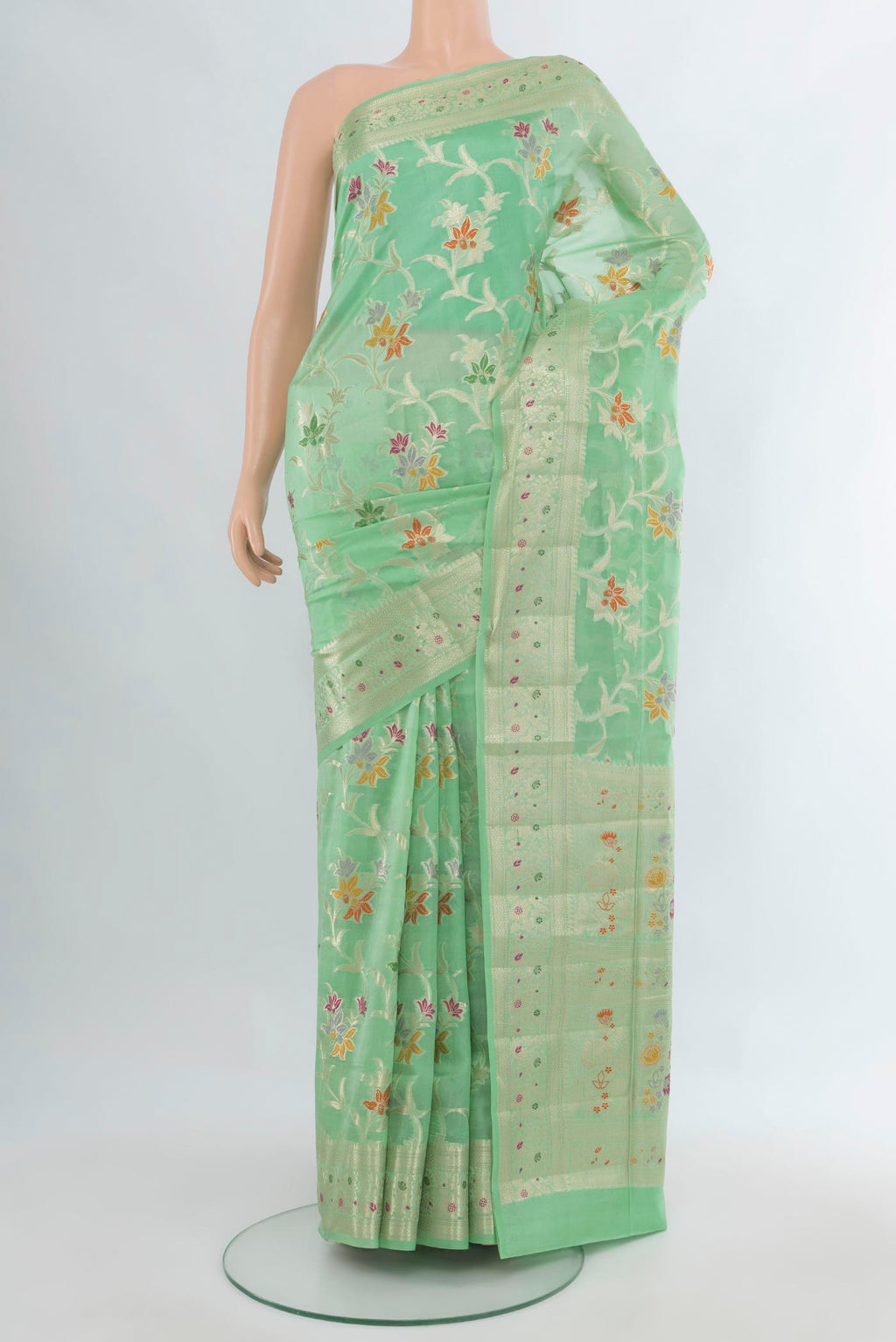 Pure Silk Mint Green Banarasi Raw Saree with Zari And Thread Butta on the body and Zari Border.  displayed on a mannequin