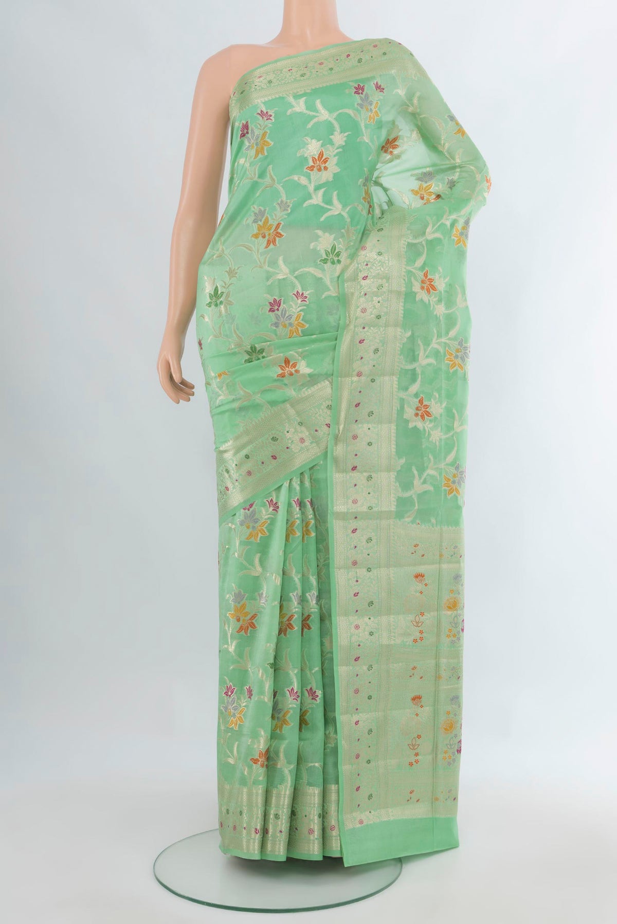 Pure Silk Mint Green Banarasi Raw Saree with Zari And Thread Butta on the body and Zari Border.  displayed on a mannequin