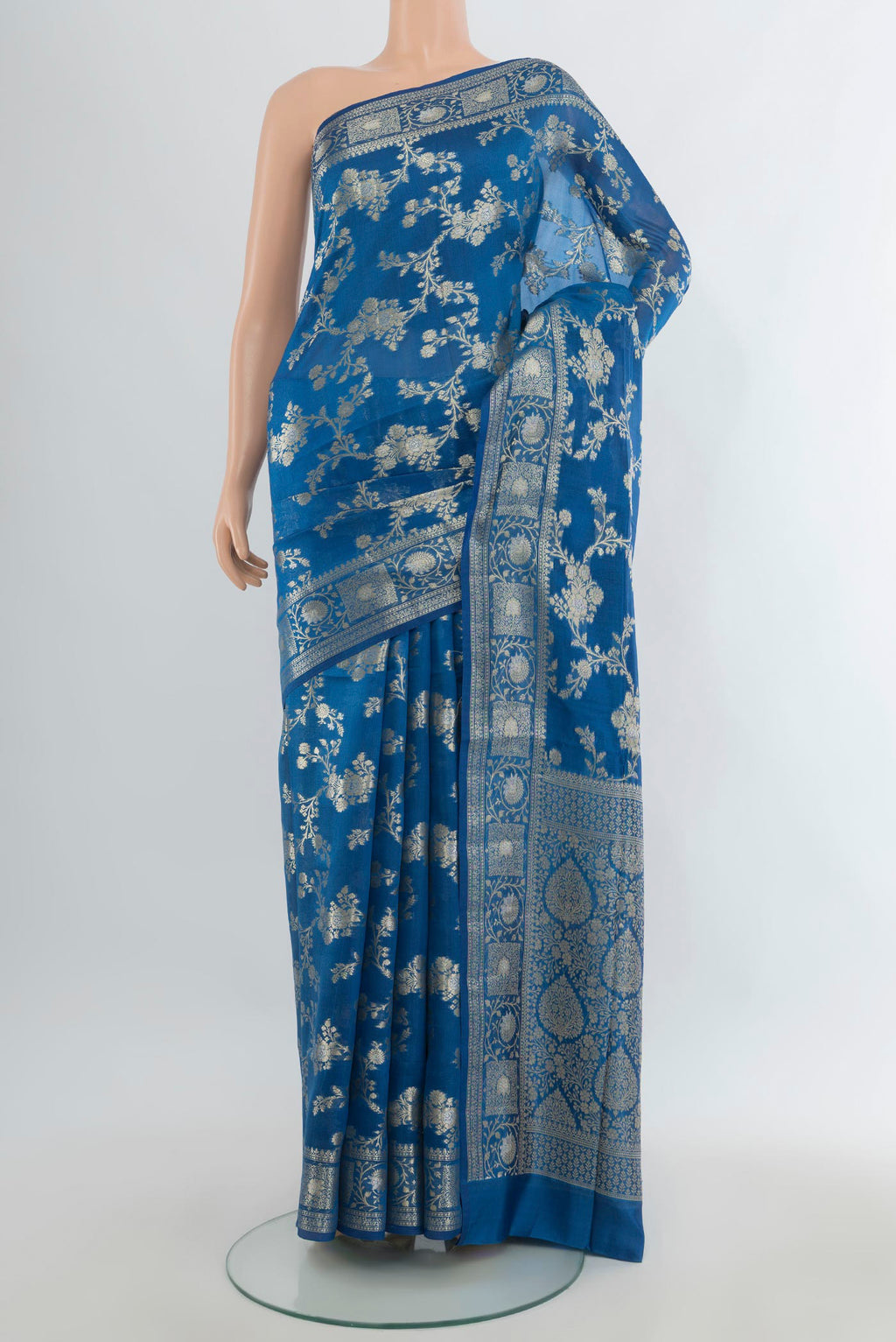 Pure Silk Light Blue Banarasi Raw Saree with Zari Butta on the body and Zari Border.  displayed on a mannequin
