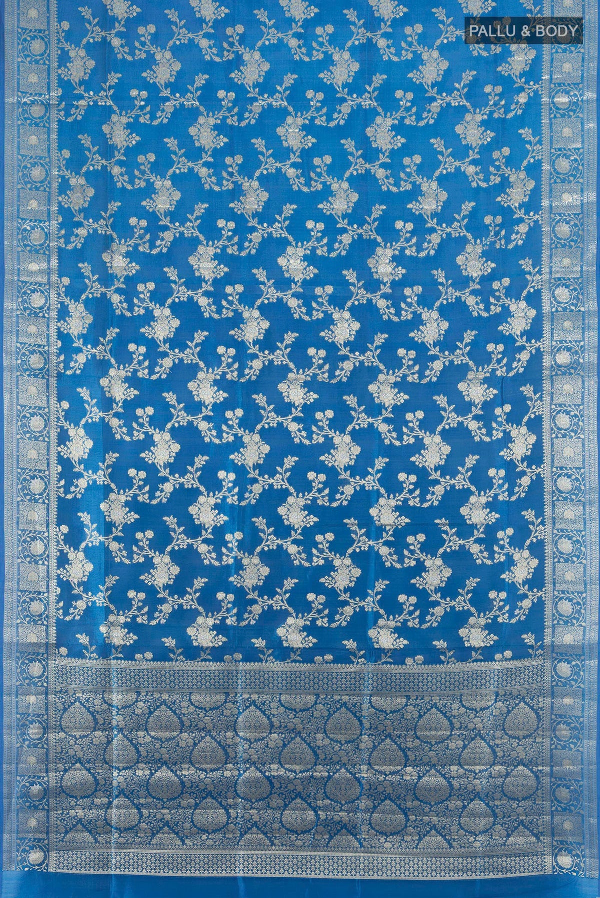 Flat view of Pure Silk Light Blue Banarasi Raw Saree with Zari Butta on the body and Zari Border. 
