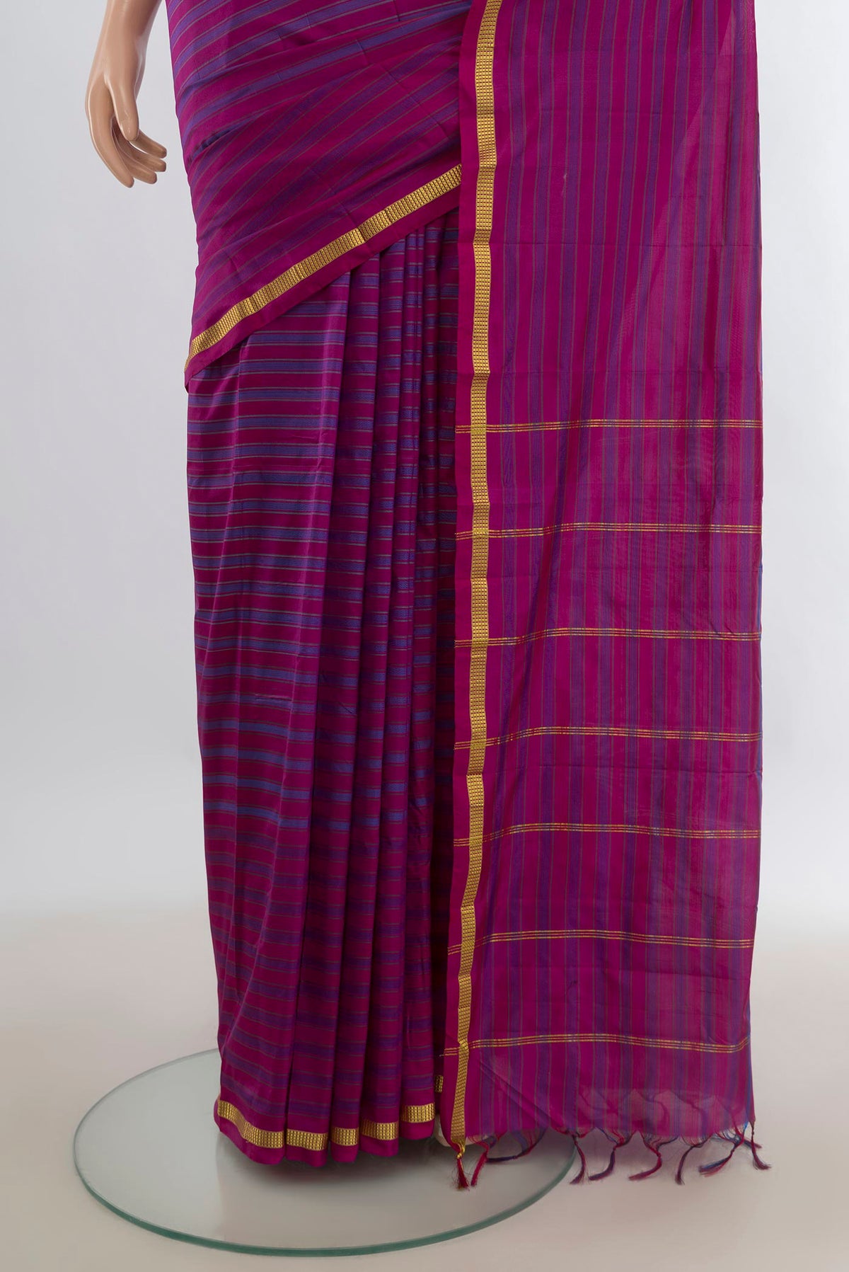 Pleats and pallu of Pure Silk Magenta Kanchipuram Saree with Stripes on the body and Zari Border. 