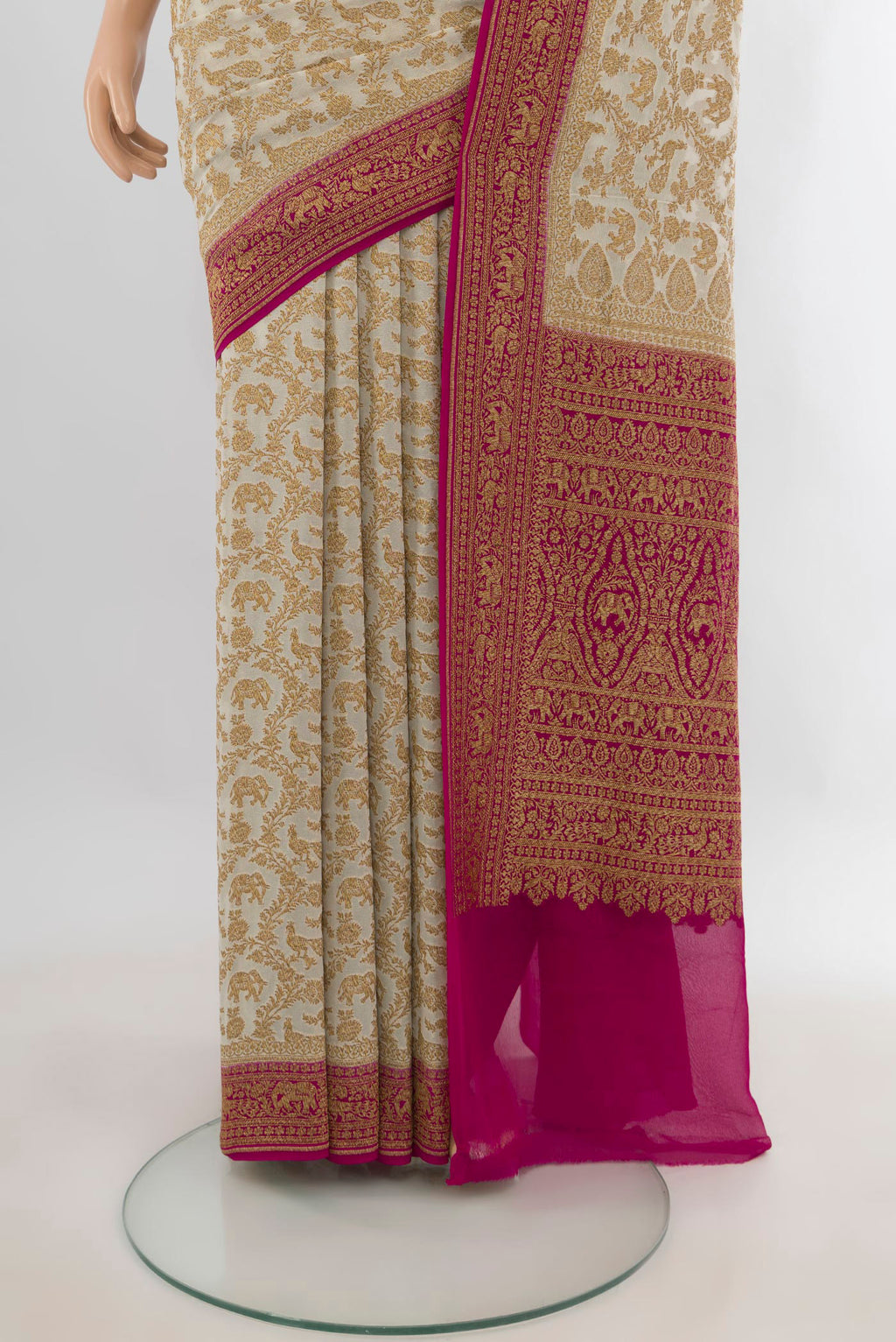 Pleats and pallu of Cream Banarasi Georgette Saree with Zari Butta on the body and Zari Border. 