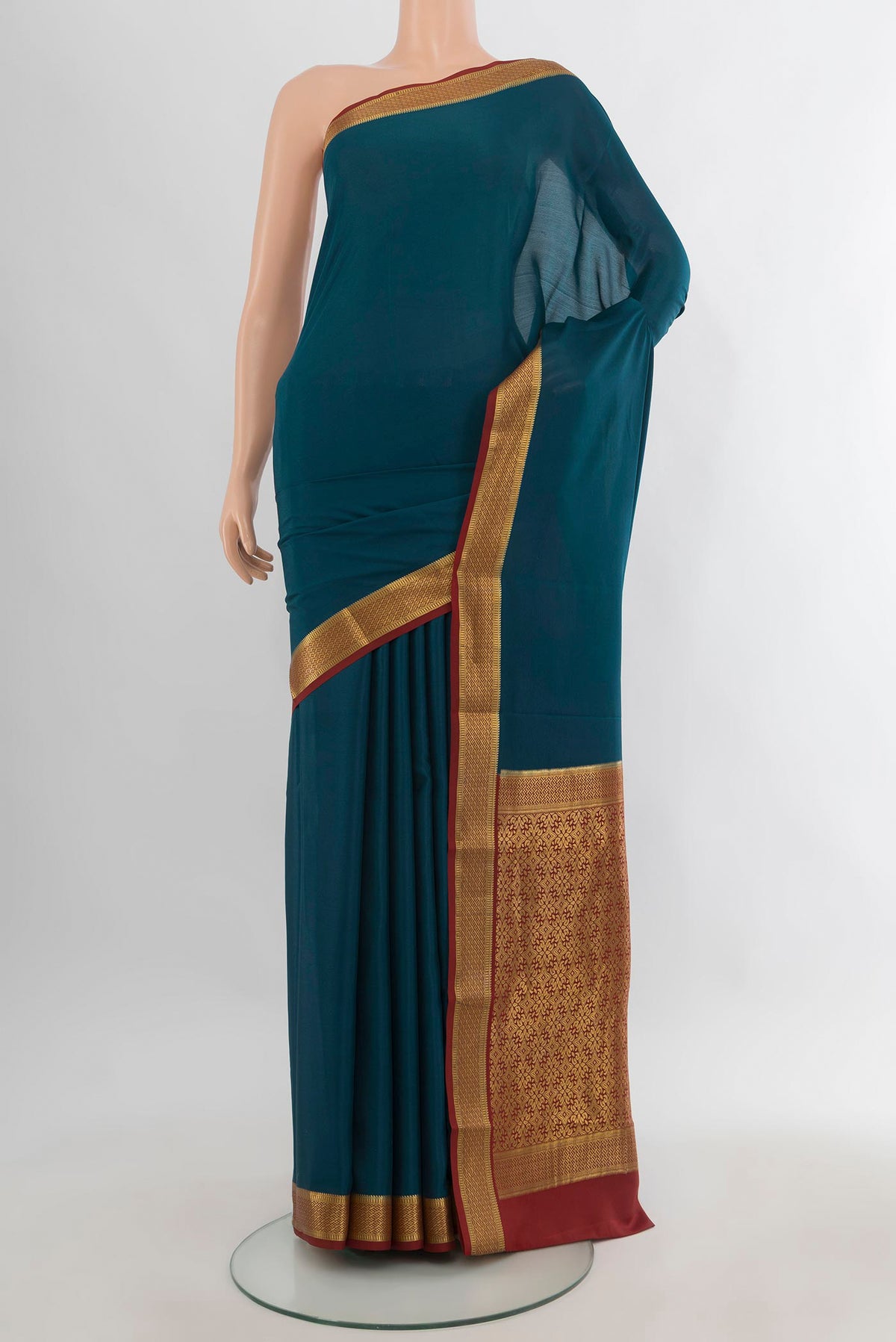 Teal Mysore Crepe Saree with Plain Body and Zari Border.  displayed on a mannequin