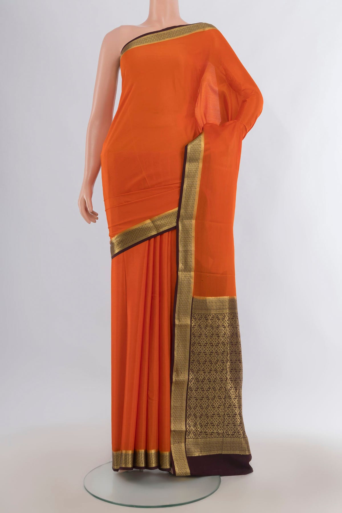 Brick Orange Mysore Crepe Saree with Plain Body and Zari Border.  displayed on a mannequin