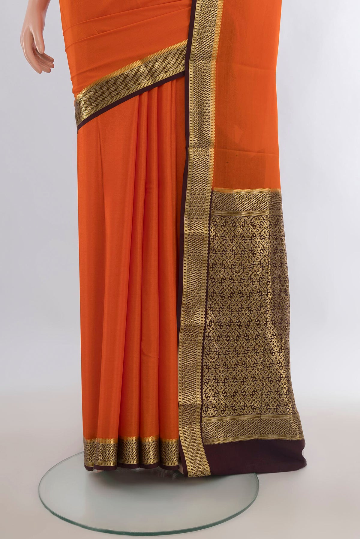 Pleats and pallu of Brick Orange Mysore Crepe Saree with Plain Body and Zari Border. 