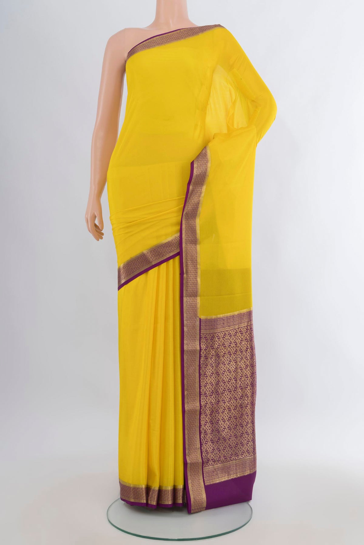 Yellow Mysore Crepe Saree with Plain Body and Zari Border.  displayed on a mannequin