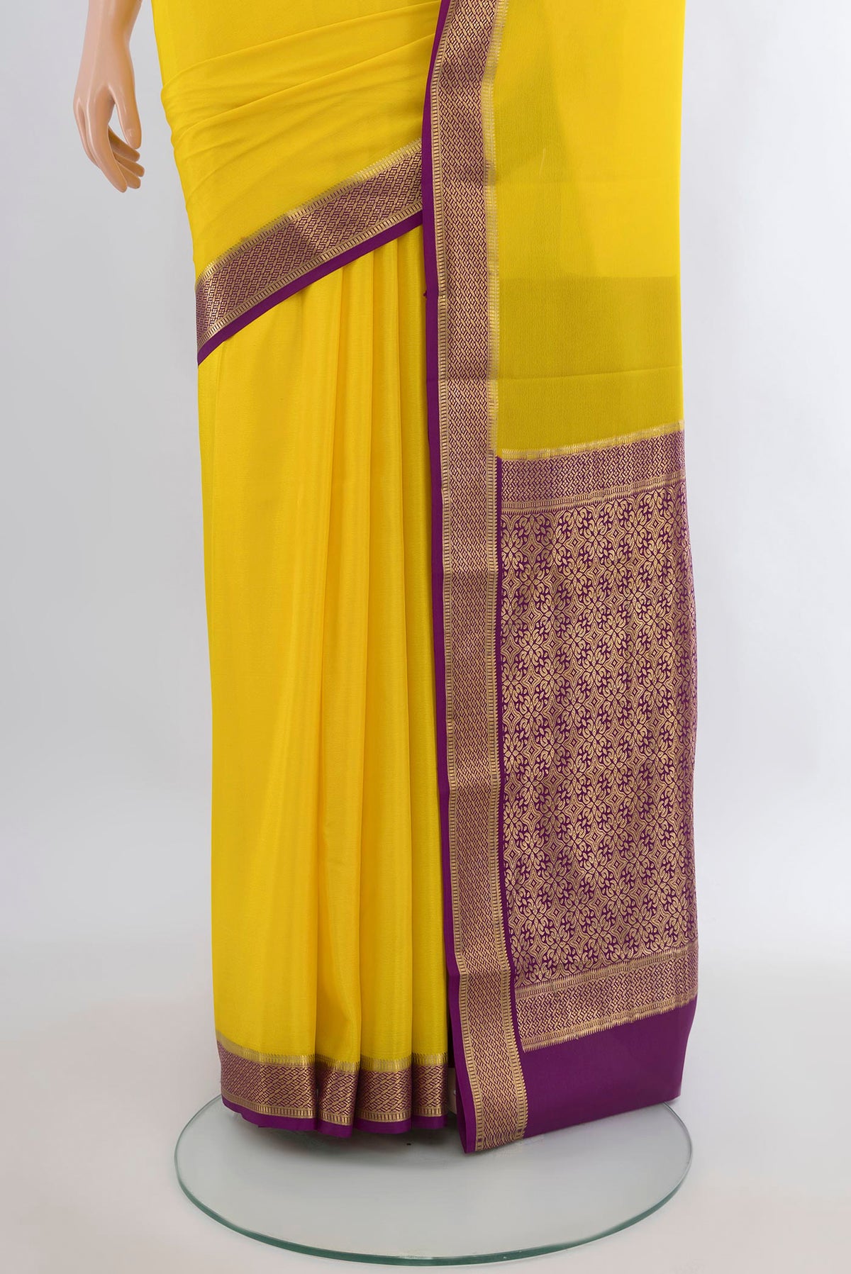 Pleats and pallu of Yellow Mysore Crepe Saree with Plain Body and Zari Border. 