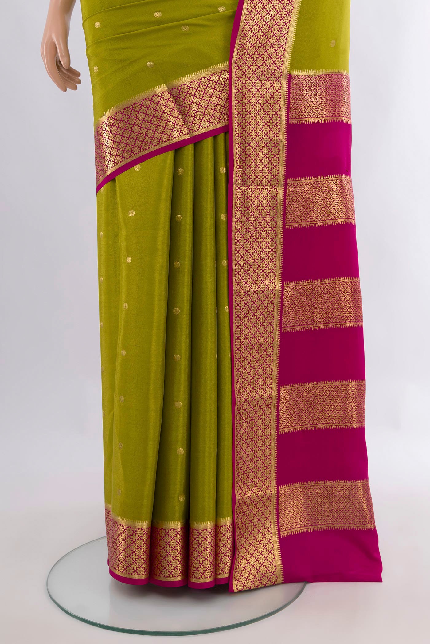 Pleats and pallu of Mehandi Green Mysore Crepe Saree with Zari Butta on the body and Zari Border. 