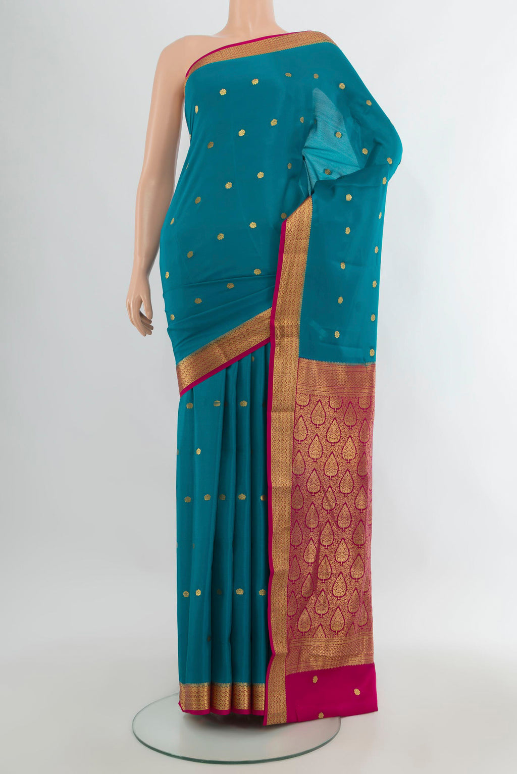 Light Blue Mysore Crepe Saree with Zari Butta on the body and Zari Border.  displayed on a mannequin