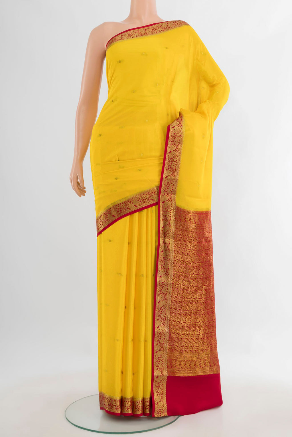 Yellow Mysore Crepe Saree with Zari Butta on the body and Zari Border.  displayed on a mannequin
