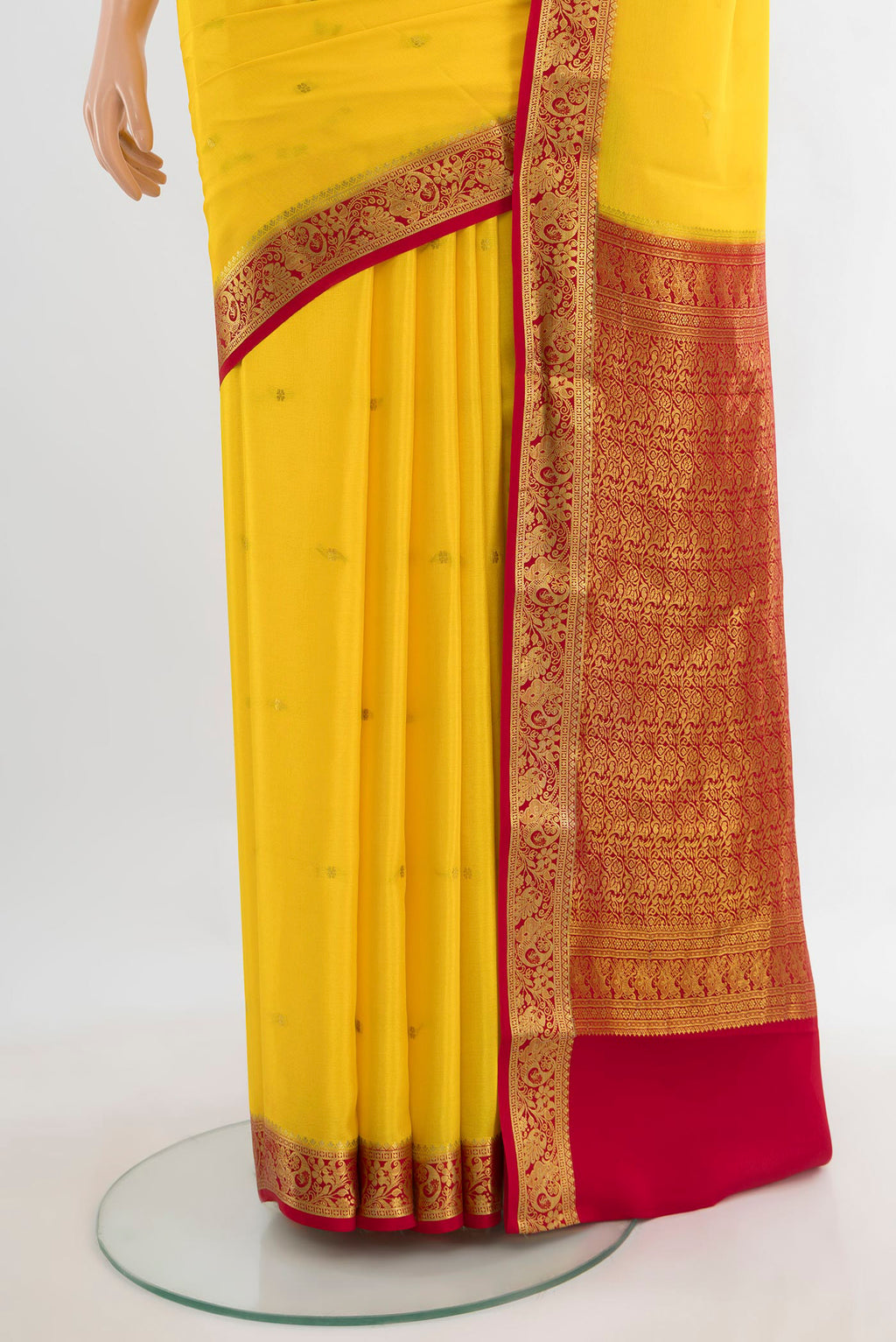 Pleats and pallu of Yellow Mysore Crepe Saree with Zari Butta on the body and Zari Border. 