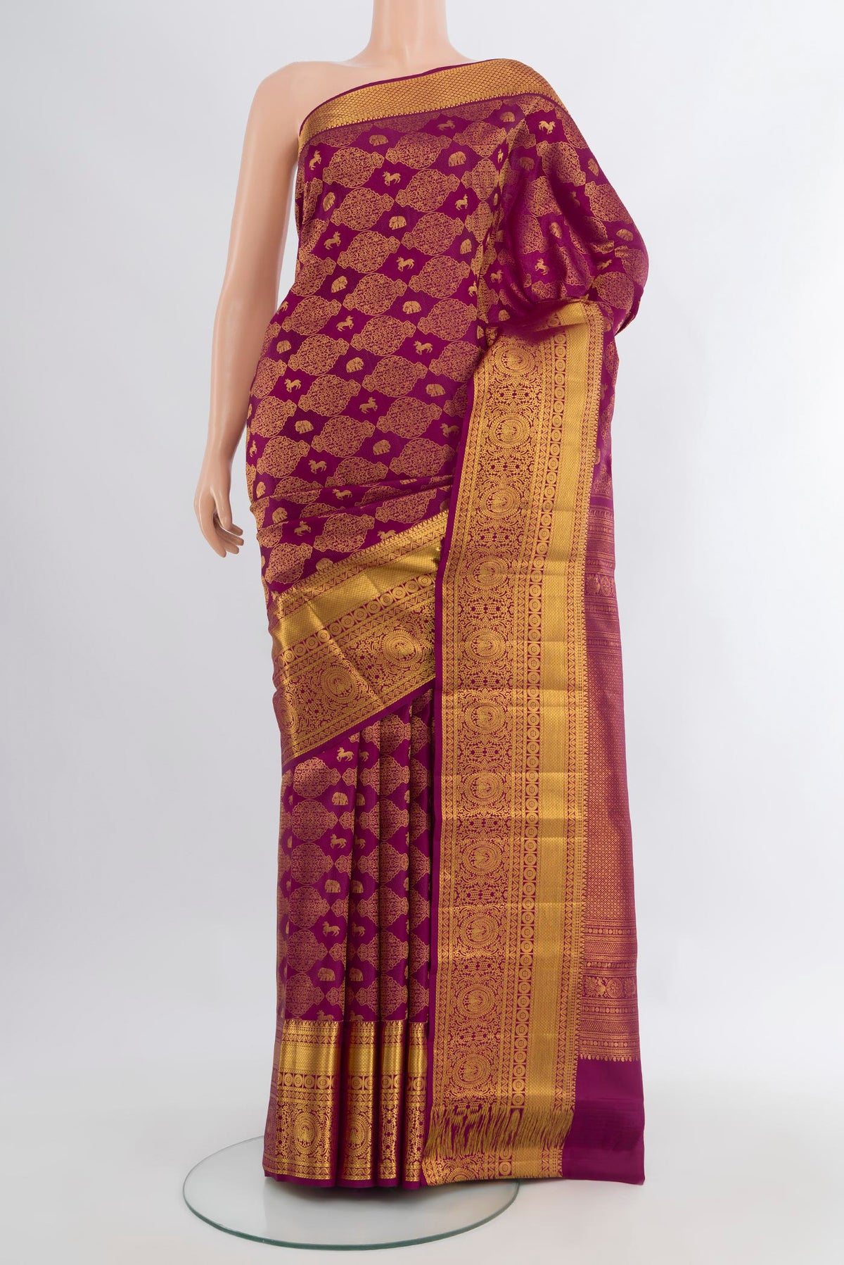 Magenta Kanchipuram Silk Saree with Zari Brocade on the body and Zari Border.  displayed on a mannequin