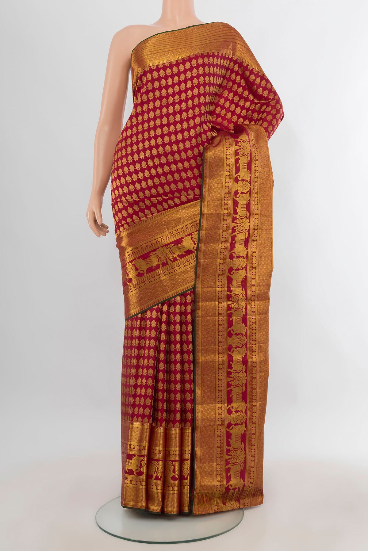 Pure Silk Maroon Kanchipuram Saree with Zari Butta on the body and Zari Border.  displayed on a mannequin