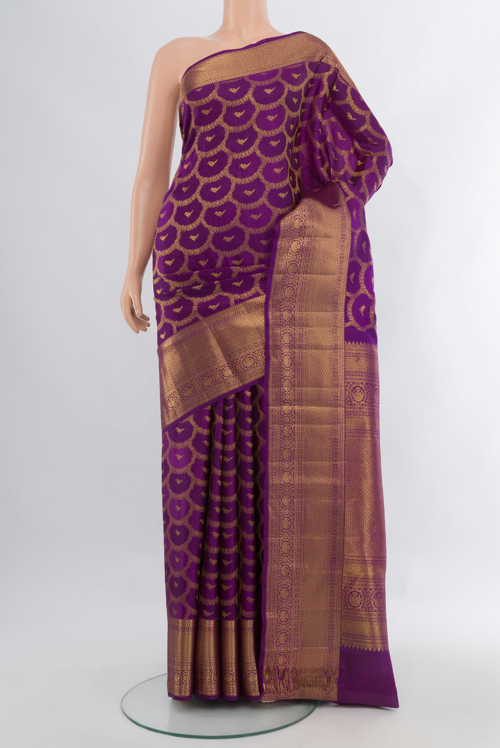 Purple Kanchipuram Silk Saree with Zari Butta on the body and Zari Border.  displayed on a mannequin