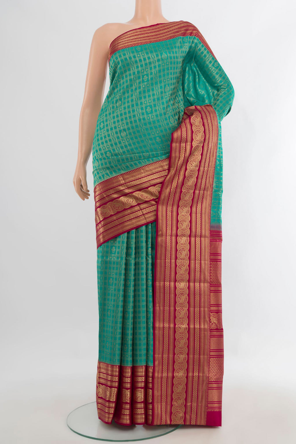 Pure Silk Sea Green Kanjivaram Saree with Zari Brocade on the body and Zari Border.  displayed on a mannequin