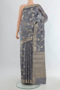 Pure Silk Grey Banarasi Raw Saree with Zari Butta on the body and Zari Border.  displayed on a mannequin