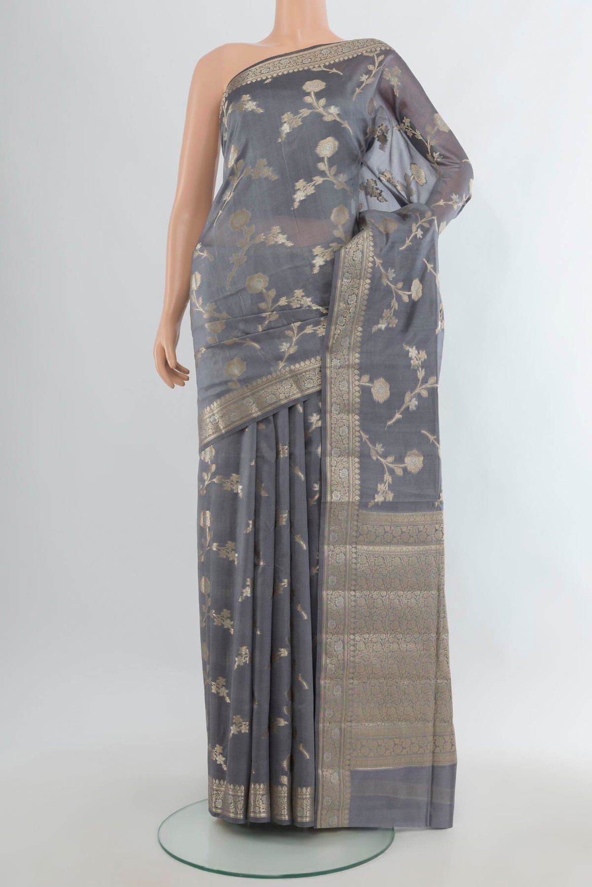 Pure Silk Grey Banarasi Raw Saree with Zari Butta on the body and Zari Border.  displayed on a mannequin