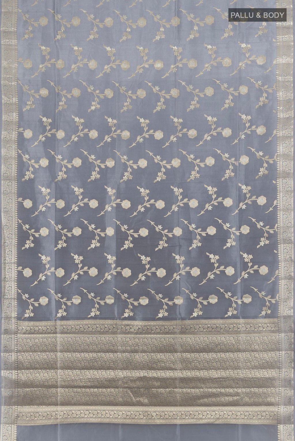 Flat view of Pure Silk Grey Banarasi Raw Saree with Zari Butta on the body and Zari Border. 