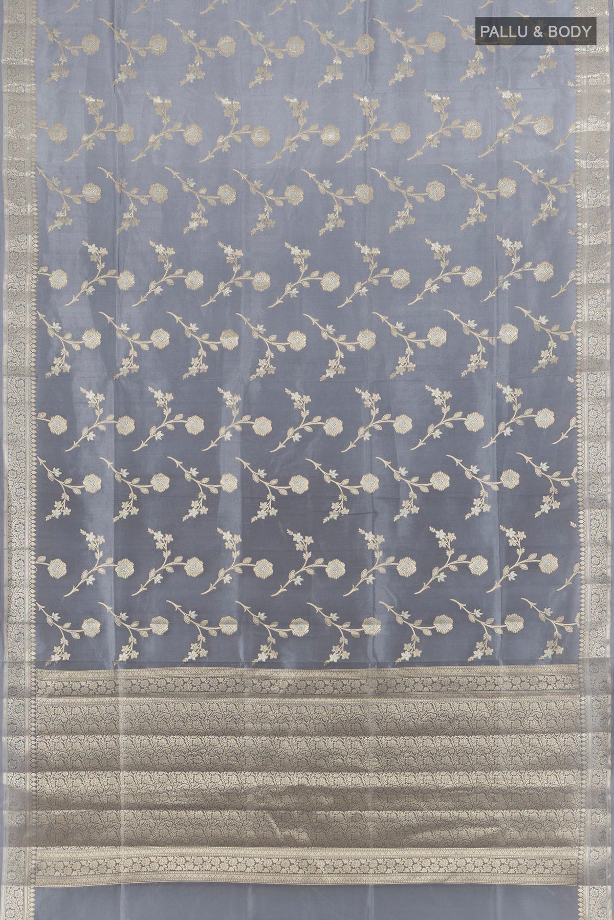 Flat view of Pure Silk Grey Banarasi Raw Saree with Zari Butta on the body and Zari Border. 