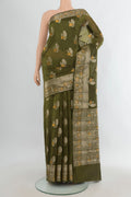 Pure Silk Green Banarasi Raw Saree with Zari Butta on the body and Zari Border.  displayed on a mannequin