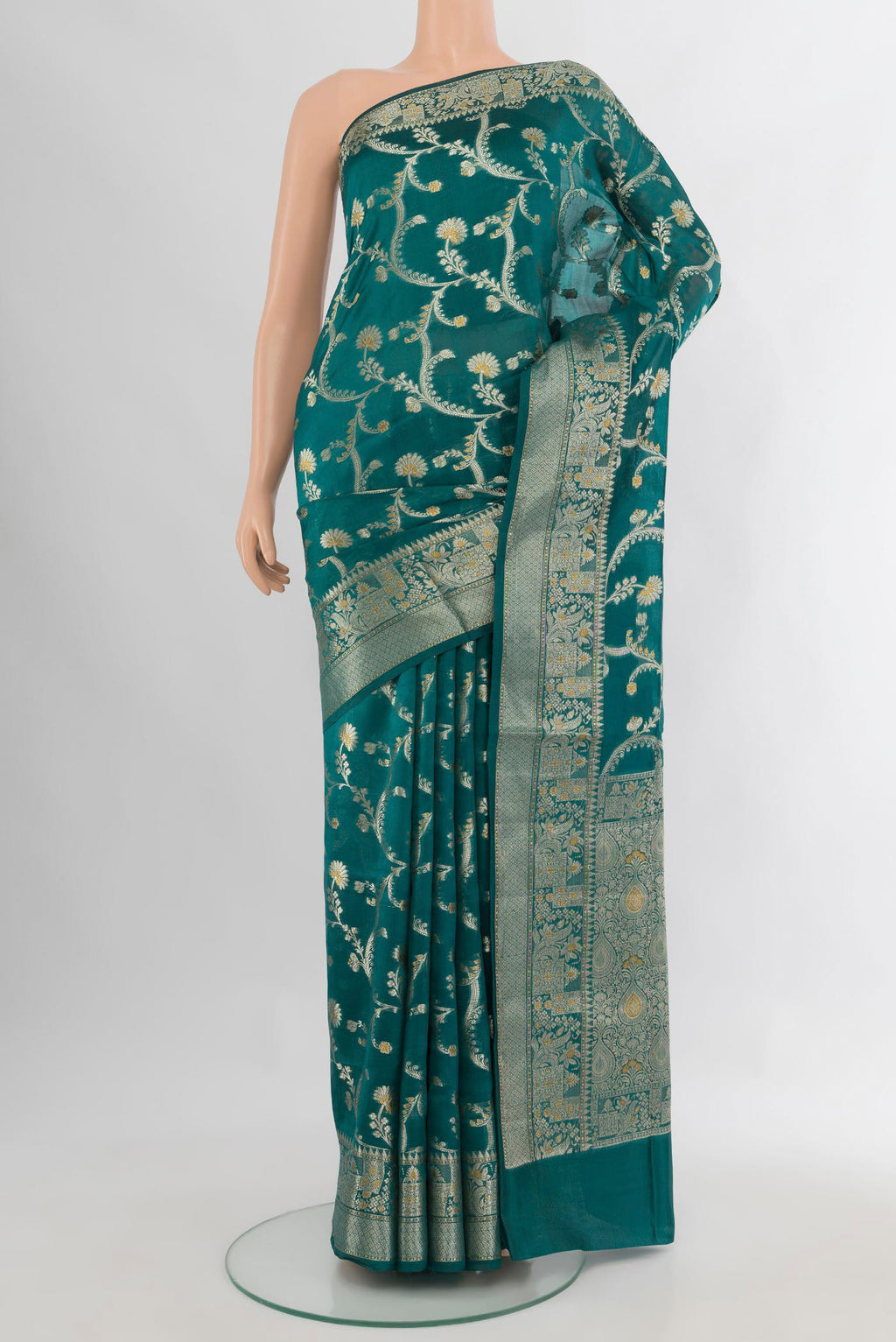 Pure Silk Peacock Blue Banarasi Raw Saree with Zari Butta on the body and Zari Border.  displayed on a mannequin