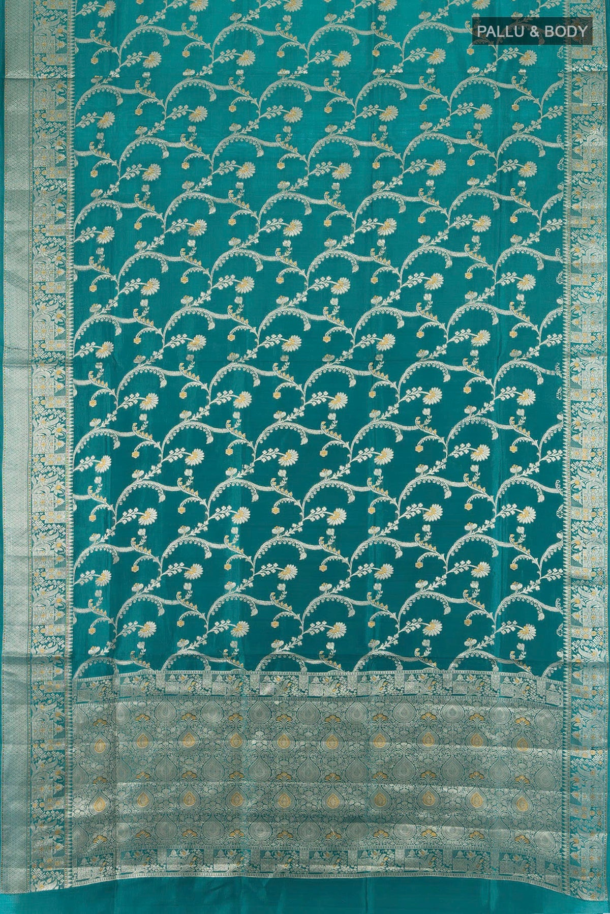 Flat view of Pure Silk Peacock Blue Banarasi Raw Saree with Zari Butta on the body and Zari Border. 