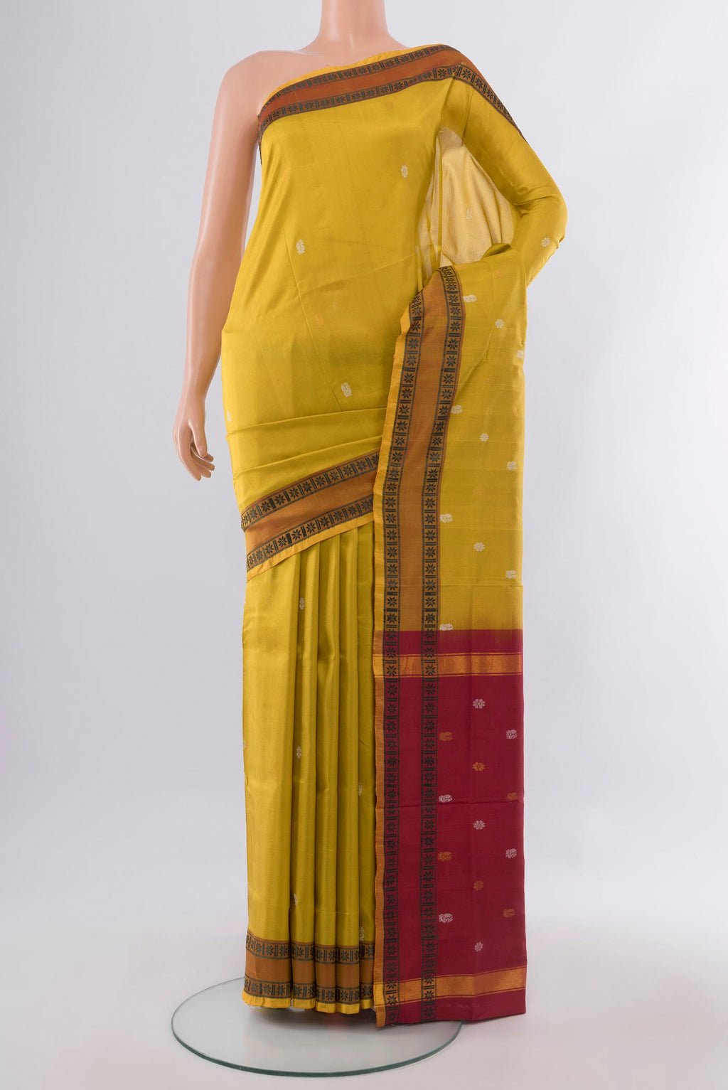 Pure Silk Yellow Uppada Saree with Thread Butta on the body and Thread Border.  displayed on a mannequin