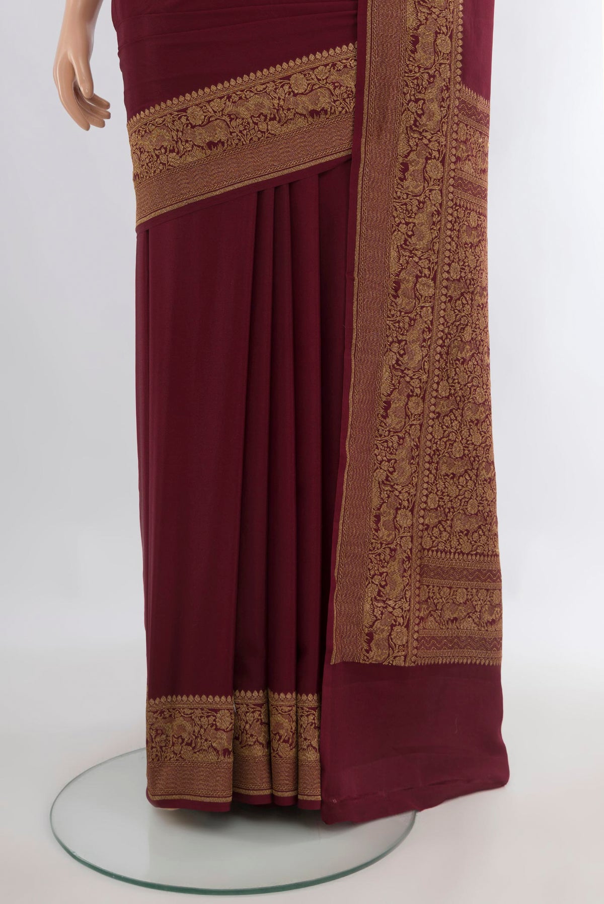 Pleats and pallu of Maroon Banarasi Georgette Saree with Plain Body and Zari Border. 