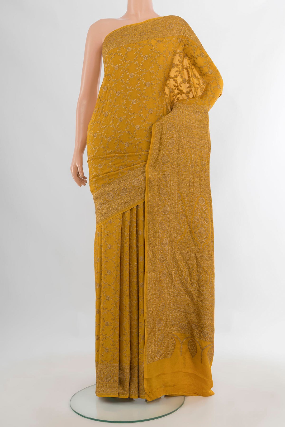 Mustard Banarasi Georgette Saree with Zari Brocade on the body and Zari Border.  displayed on a mannequin