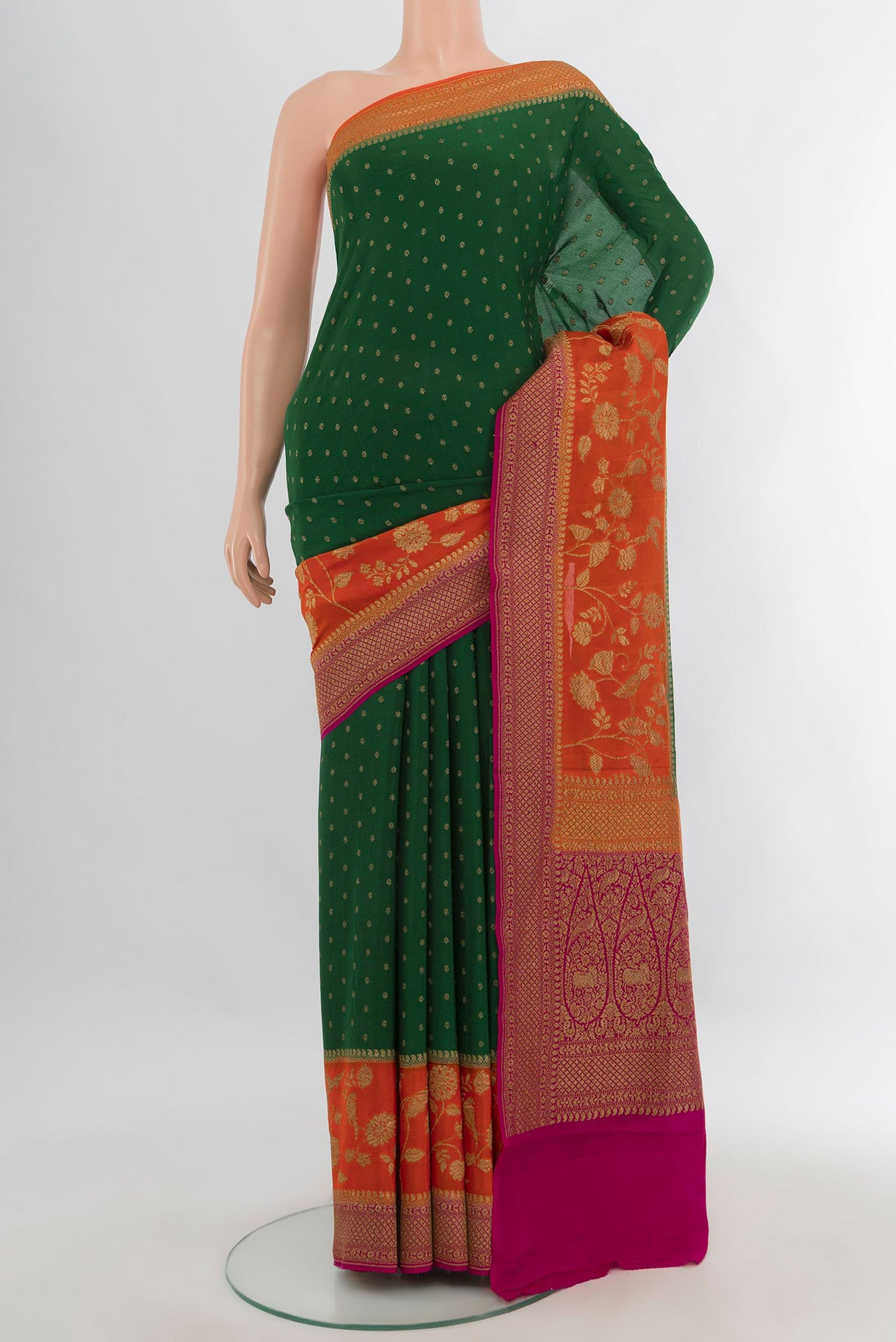 Bottle Green Banarasi Georgette Saree with Zari Butta on the body and Zari Border.  displayed on a mannequin