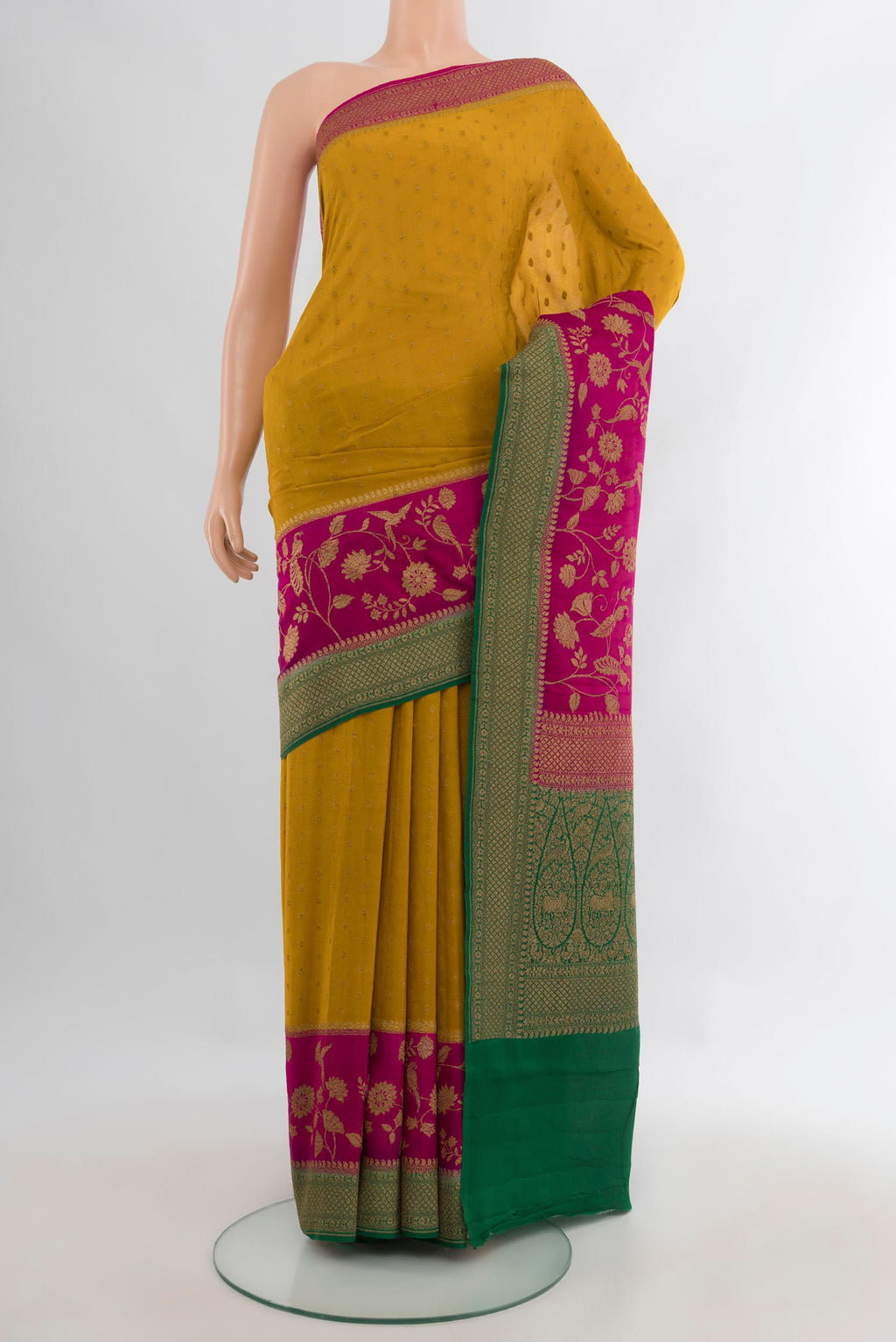 Mustard Banarasi Georgette Saree with Zari Butta on the body and Zari Border.  displayed on a mannequin