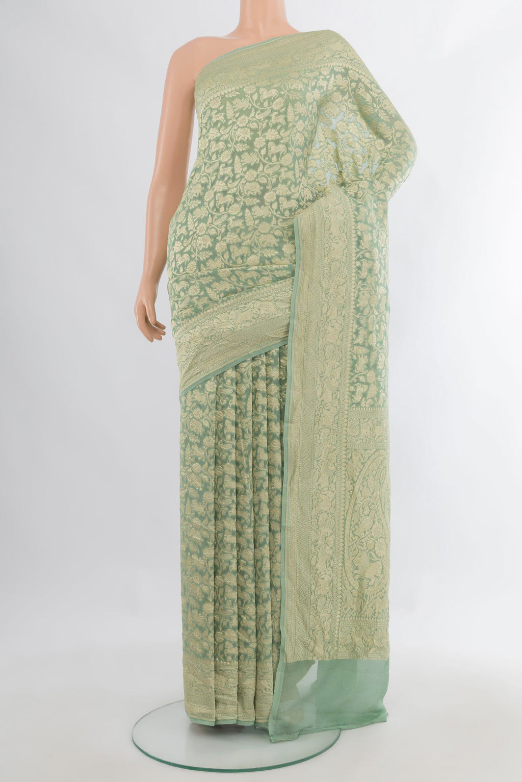 Light Green Banarasi Georgette Saree with Zari Brocade on the body and Zari Border.  displayed on a mannequin
