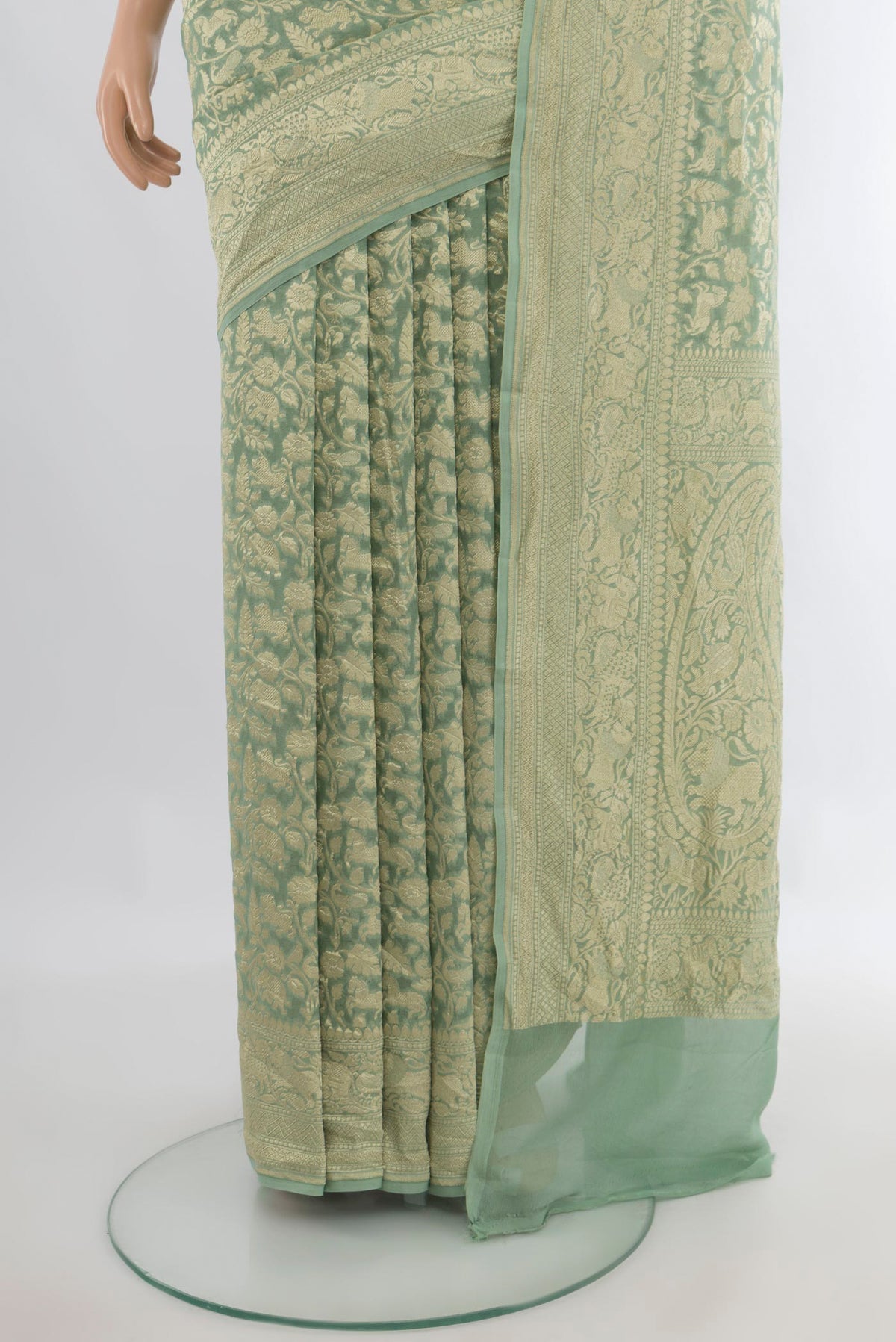 Pleats and pallu of Light Green Banarasi Georgette Saree with Zari Brocade on the body and Zari Border. 