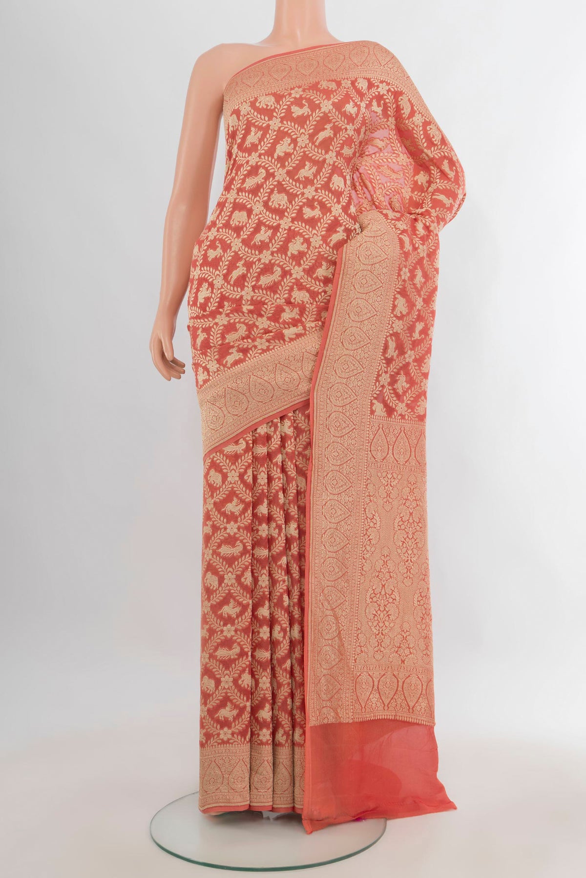 Peach Banarasi Georgette Saree with Zari Butta on the body and Zari Border.  displayed on a mannequin