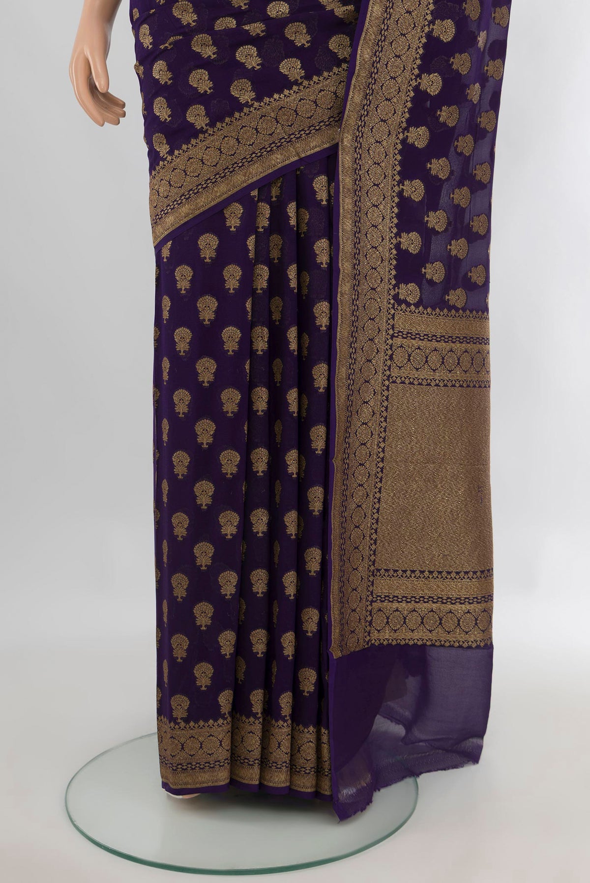 Pleats and pallu of Navy Blue Banarasi Georgette Saree with Zari Butta on the body and Zari And Thread Border. 