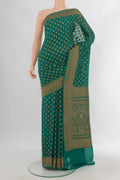 Green Banarasi Georgette Saree with Zari Butta on the body and Zari Border.  displayed on a mannequin