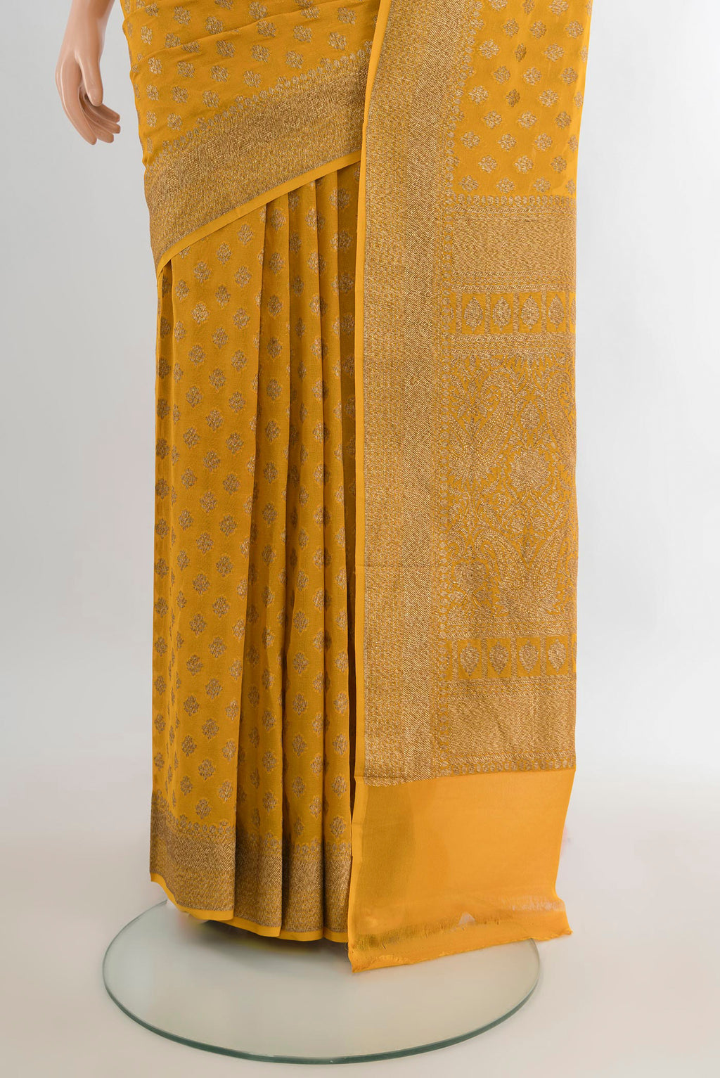 Pleats and pallu of Yellow Banarasi Georgette Saree with Zari Brocade on the body and Zari Border. 