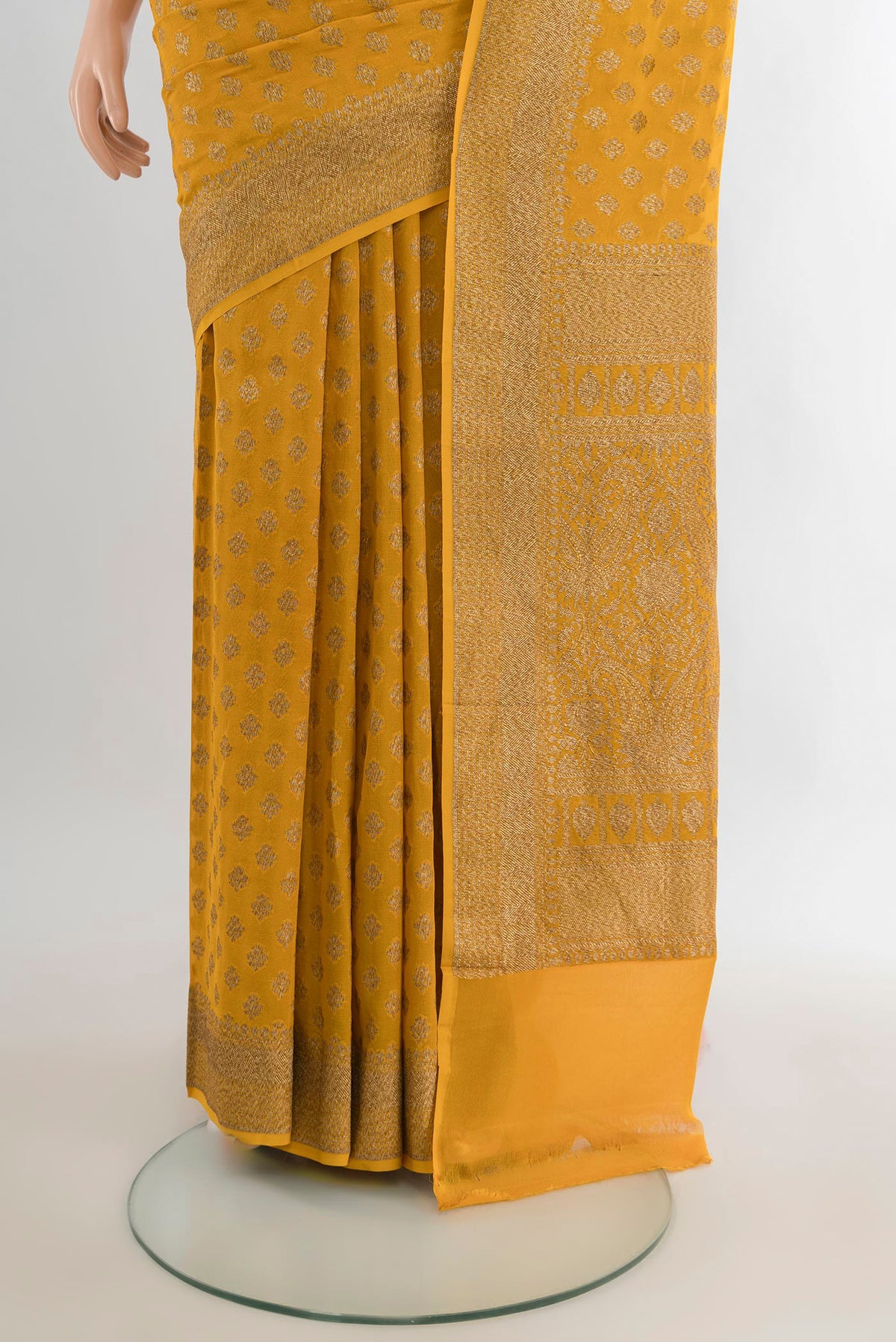 Pleats and pallu of Yellow Banarasi Georgette Saree with Zari Brocade on the body and Zari Border. 