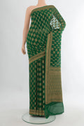 Bottle Green Banarasi Georgette Saree with Zari Butta on the body and Zari Border.  displayed on a mannequin