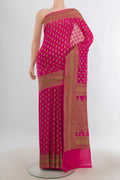 Rani Pink Banarasi Georgette Saree with Zari Butta on the body and Zari Border.  displayed on a mannequin