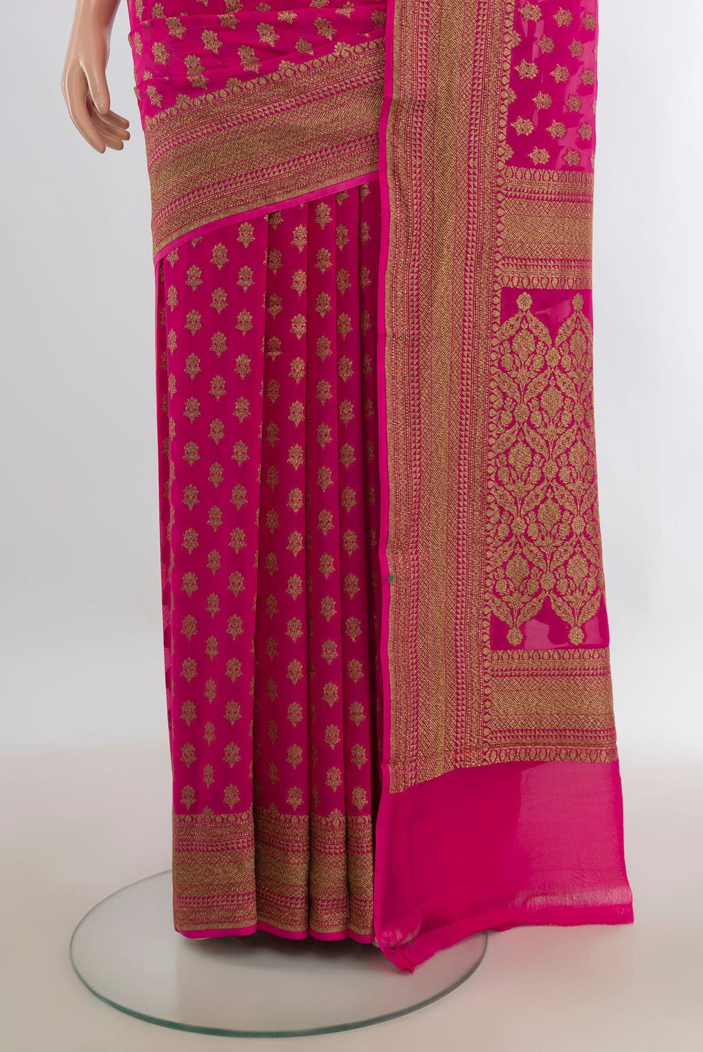 Pleats and pallu of Rani Pink Banarasi Georgette Saree with Zari Butta on the body and Zari Border. 